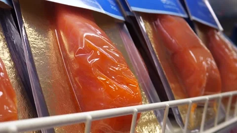 Red fish fillet in vacuum packaging on a shop window. Trout fillet. 스톡 동영상 310134349