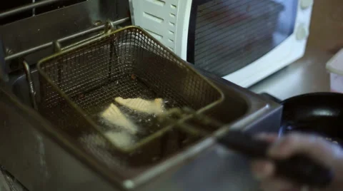 Red fish is fried in a deep fryer Stock Footage 59699742