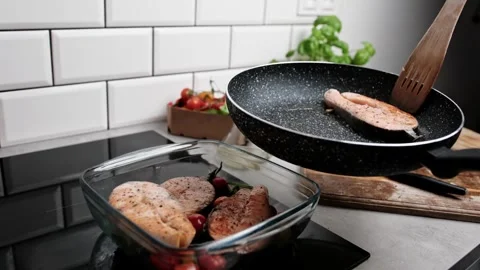 Red Fish Salmon Frying In A Pan On The Kitchen Stove Stock Footage 338355469