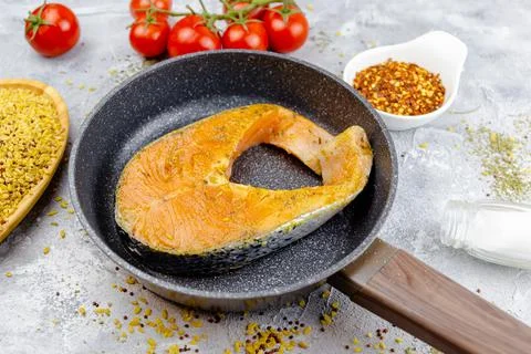 Red fish steak in a pan Stock Photos