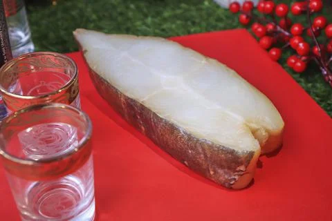 Red fish on the table, a slice of fish, seafood and alcohol, green lawn, salted Stock Photos