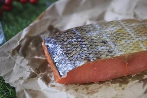 Red fish on the table, a slice of fish, seafood and alcohol, green lawn, salted Stock Photos