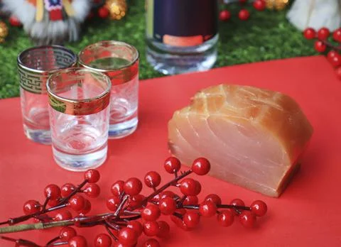 Red fish on the table, a slice of fish, seafood and alcohol, green lawn, salted Stock Photos