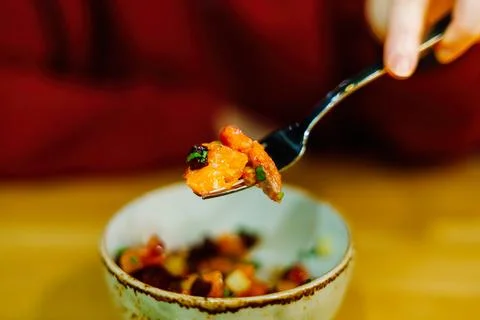 Red fish with vegetables on a fork Stock-Fotos