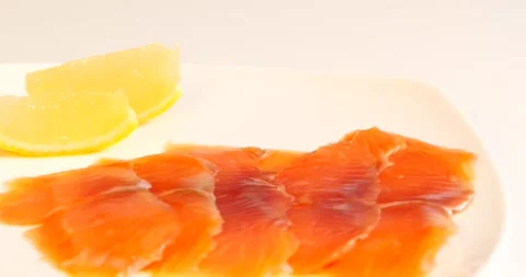 Red fish on a white dish with lemon Stock Footage 141945996