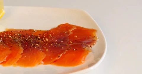 Red fish on a white dish with lemon Stock Footage 141946015