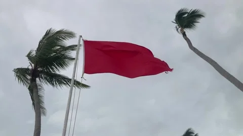 Red flag on the beach to indicate warning sign, no swimming in current 스톡 동영상 285589934