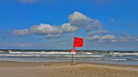 Red flag on the beach. Stock Photos