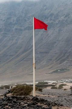 Red flag on a beach Stock Photos