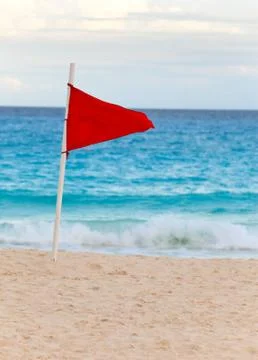 Red flag on the beach Stock Photos