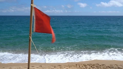 Red flag on the beach warned of the danger. No swimming in the sea, ocean - no l Stock Footage 113101148