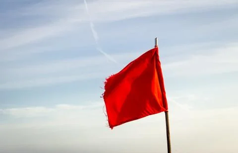 Red Flag on Clear Day Stock Photos