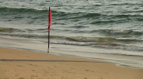 The red flag of danger on the beach Stock Footage 37592516