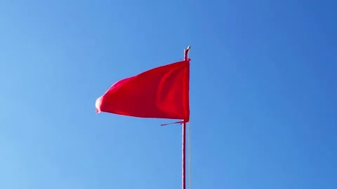 Red flag flutters in wind Vidéo 337661402