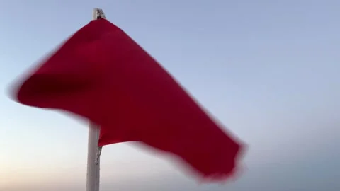 A red flag flutters in the wind in the sky Stock Footage 246443236