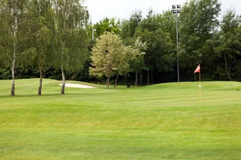 Red flag on a golf course Stock Photos