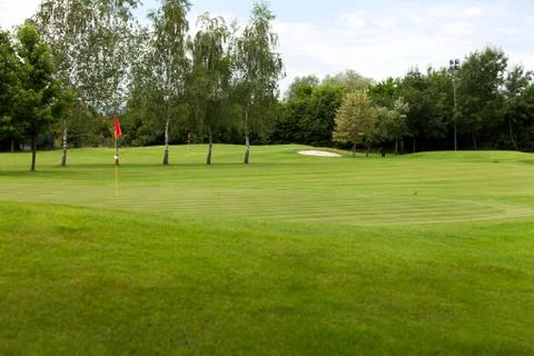 Red flag on a golf course Stock Photos