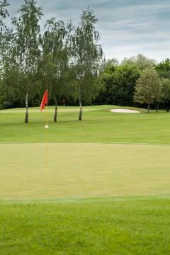 Red flag on a golf course Stock Photos