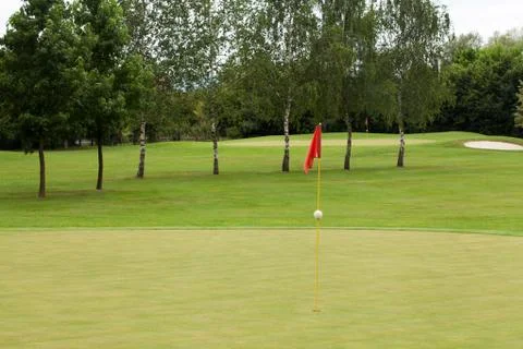 Red flag on a golf course Stock Photos