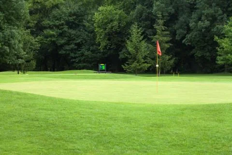 Red flag on a golf course Stock Photos