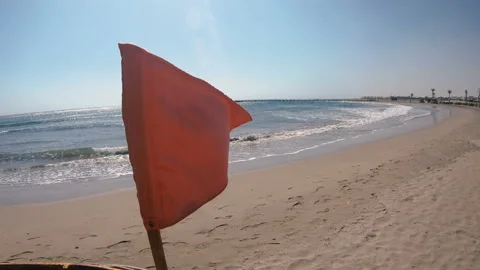 Red flag hanging on the beach Video stock 107348130
