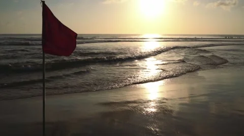 Red flag on Kuta beach at sunset time Stock Footage 63521217