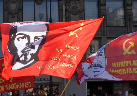The red flag with the leader on the flagpole Stock Photos