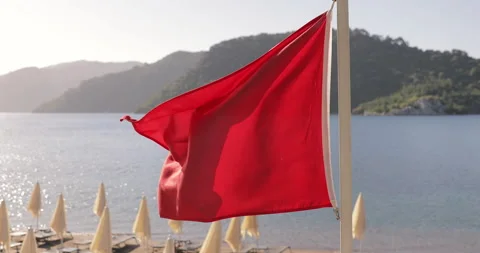 Red flag on the Lifeguard point on the beach. Bad weather for swimming. Storm Stock Footage 154335419