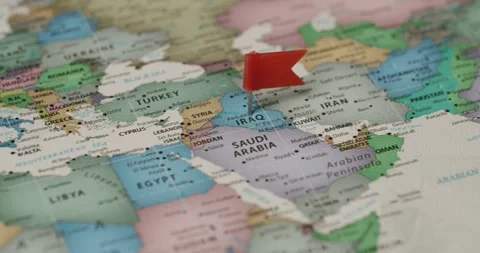 Red flag marking Iraq on a world map for travel planning Stock Footage 345588512
