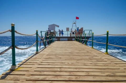 Red flag on the pier Stock Photos