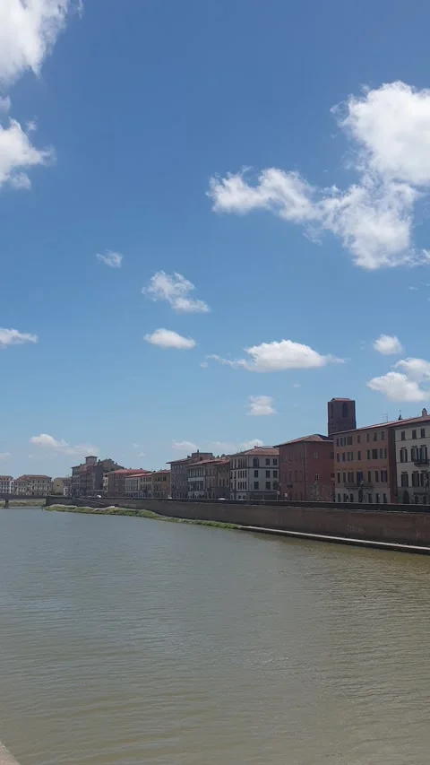 The red flag of Pisa waving in the wind on the bridge "Ponte di Mezzo", Arno Stock Footage 133915162
