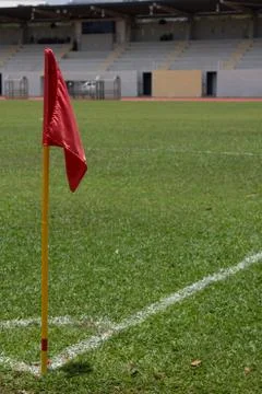 Red flag pole at corner kick marking of soccer field Stock Photos