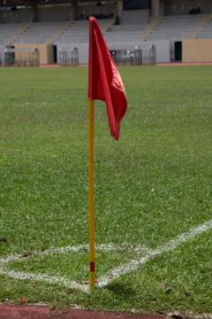 Red flag pole at corner kick marking of soccer field Stock Photos