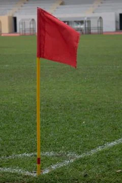 Red flag pole at corner kick marking of soccer field Stock Photos