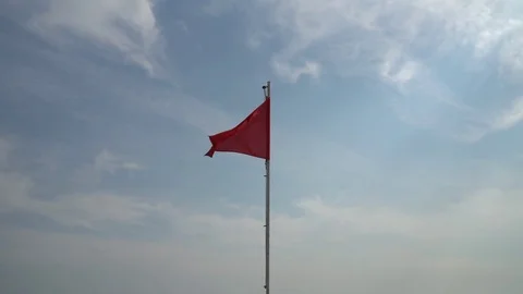 Red flag with sky at the background Stock Footage 80056342