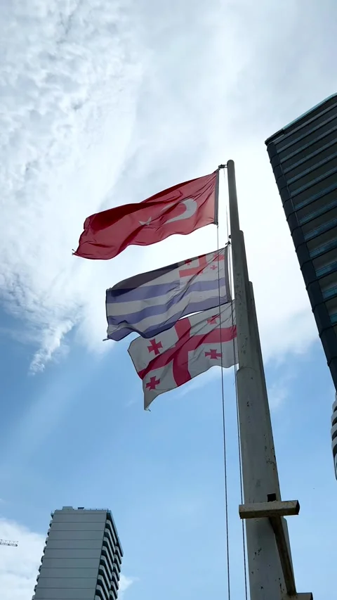 Red flag of Turkey, flag of Georgia, flag of Adjara with white and blue stripes. Video stock 281796202
