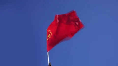 The red flag of the USSR develops in the wind against the blue sky Stock Footage 153427716