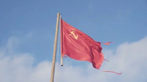 The red flag of the USSR develops in the wind against the lue sky Stock Footage 168358423