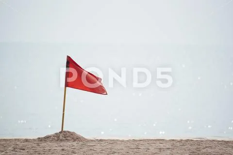 A red flag warning danger on the beach Stock Photos