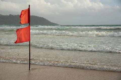 A red flag warning of danger on the beach Stock Photos
