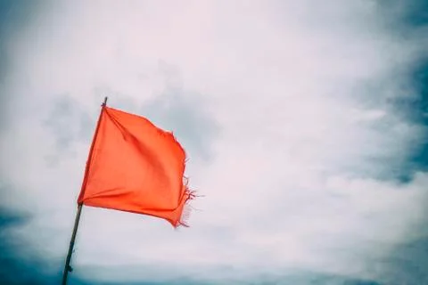 Red flag warning flags wind blue sky Foto stock