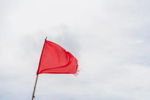 Red flag warning flags wind blue sky Foto stock