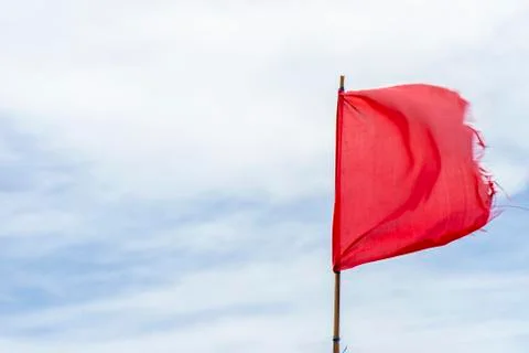 Red flag warning flags wind blue sky Stock Photos