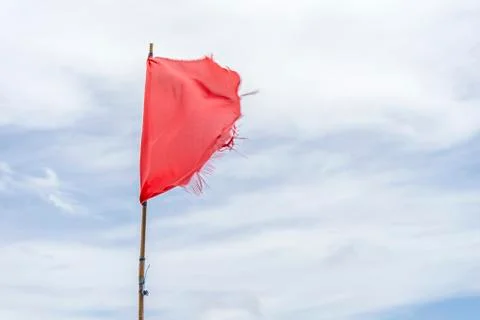 Red flag warning flags wind blue sky Stock Photos
