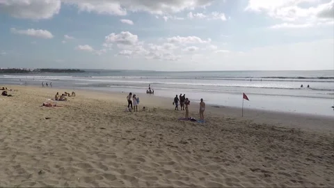 Red Flag Warning, People Relax on Kuta beach, Bali, Indonesia Stock Footage 303092787