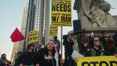 Red flag waves beside Peoples Needs Not War sign at protest monument Stock Footage 341658337