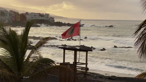 Red Flag Waves at Playa de Castillo Signaling Rough Seas in Tenerife Video stock 330898984