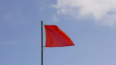 Red flag waving on blue sky background Vídeo Stock 249508618