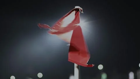Red flag is waving in the wind in corner kick zone during soccer match at night Stock Footage 243161897
