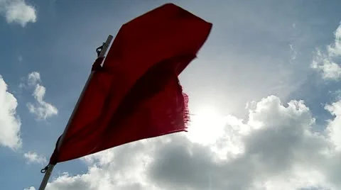 Red Flag w:Sunburst in Strong Wind Video stock 12448445